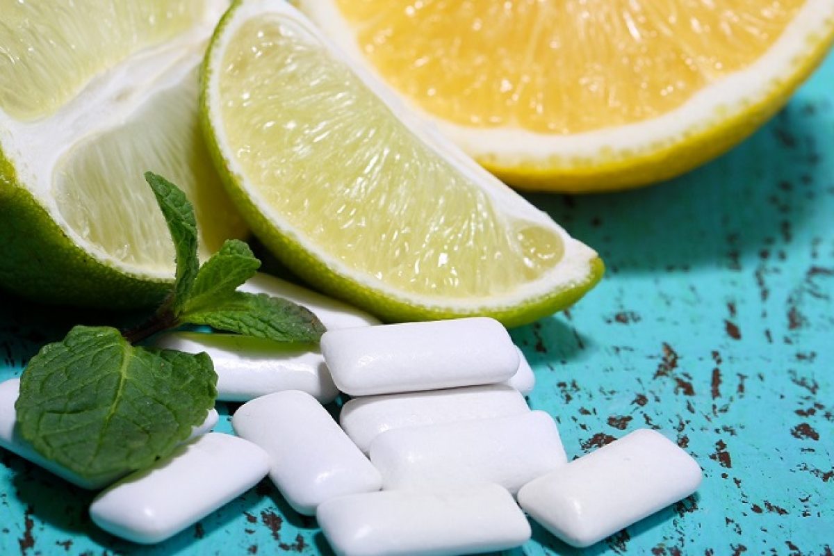 Chewing gums with fruit taste,   on color wooden background